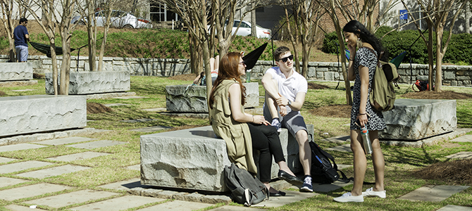 students sitting and talking in memorial garden